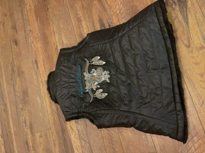 Black quilted vest with fur trim embroidered with Cowgirl Alliance roses and arrows design