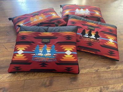 Embroidered Pendleton-style stadium seat cushions with Brantons Arena rodeo cowboys logo