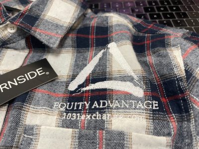 Plaid Burnside flannel shirt with embroidered Equity Advantage 1031 exchange company logo