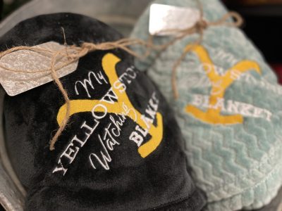 Embroidered Yellowstone TV show watching blankets with Y brand logo in teal and black