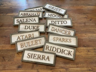 Laser cut wooden horse stall name signs with raised 3D letters in rustic frames