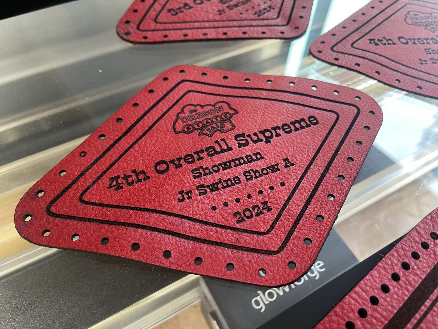 Close-up of laser engraved red leather patch for Oregon State Fair Overall Supreme Showman award