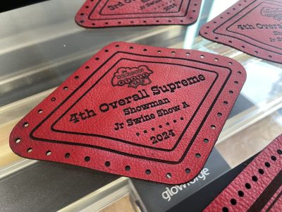Close-up of laser engraved red leather patch for Oregon State Fair Overall Supreme Showman award