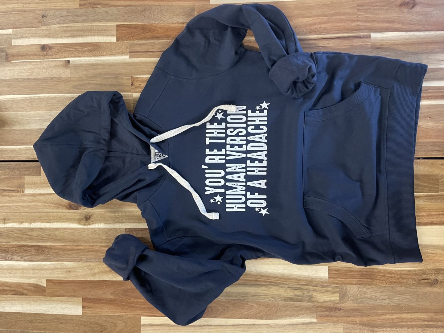 Navy blue hoodie with screen printed You Are The Human Version Of A Headache funny quote