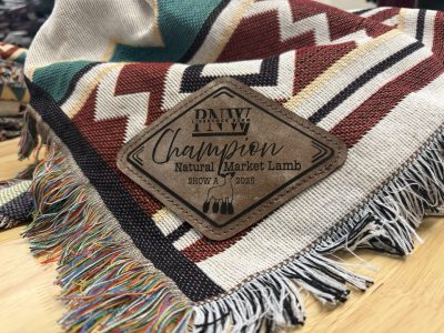 Laser engraved leather patch on southwestern blanket PNW Livestock Expo Champion Natural Market Lamb 2025