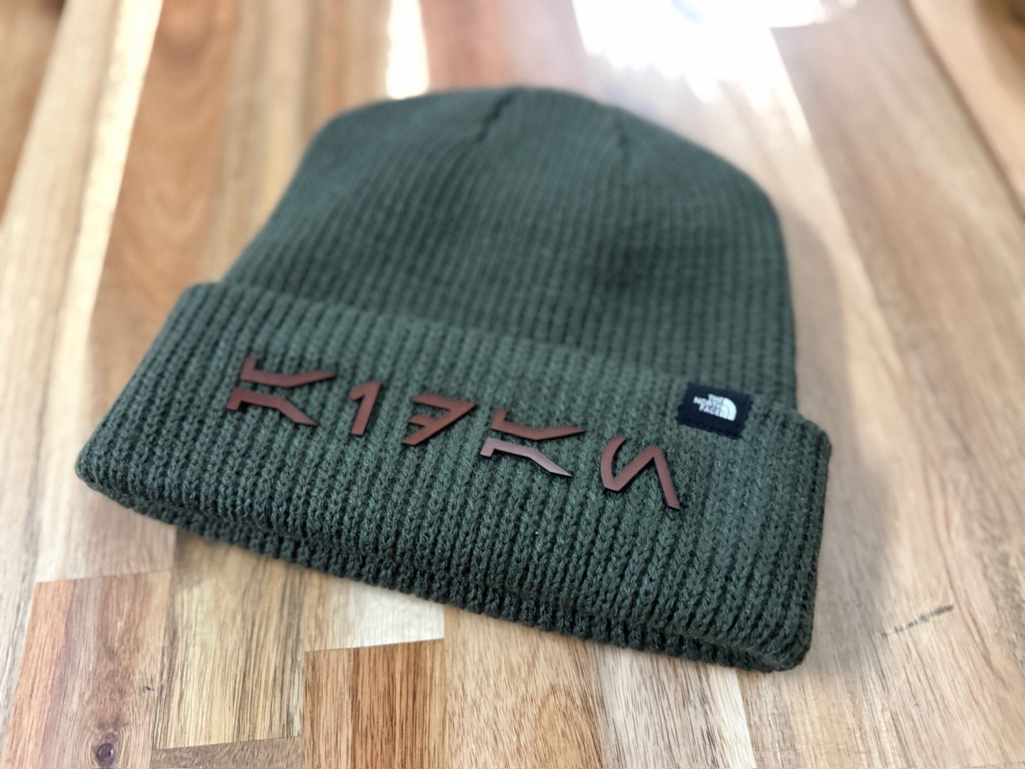 Green North Face beanie with laser cut leather letter branding K17FN custom personalized hat